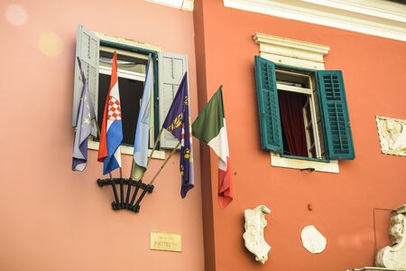 five flags on the window of the town hall in Rovinj, Croatia. Italian flag, European flag , Croatian flag , town flag .の写真素材