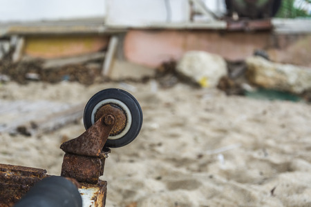 Rusty wheel Upside down on a beachの写真素材