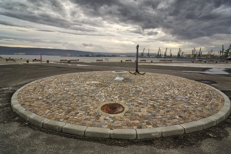 Varna seaport seascape, anchor and roundabout in the foreground against overcast skyの写真素材