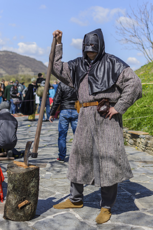 VELIKO TARNOVO,BULGARIA, APRIL 04 2015, false executioner taking the pose and making the show for the tourist at the medieval fair in Veliko Tarnovoのeditorial素材