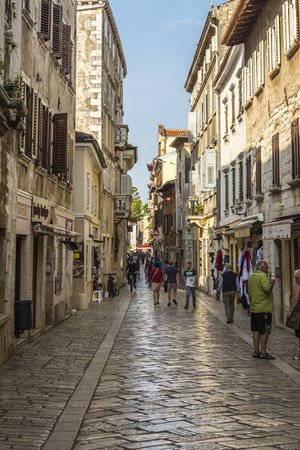 POREC, CROATIA, SEPTEMBER 24, 2017: Tourist visiting the old street of Porec and buying goods from the merchantのeditorial素材