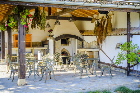 Patio with Stone oven with iron table and chair and decorative plants and flowersの写真素材