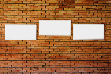 3 blank frame mock up on a old brick wallの写真素材