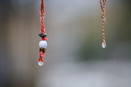 Martenitsa with smile and water drop under the rainの写真素材