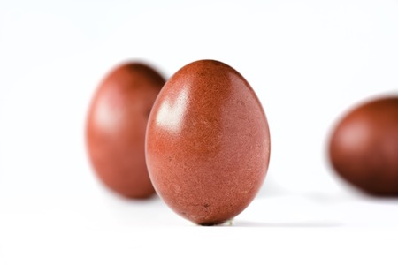 Close up of a red easter egg isolated on whiteの写真素材