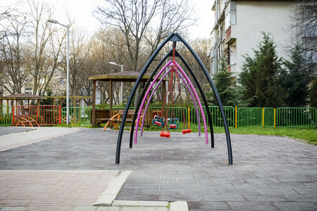 Kids swing in the middle of a playground