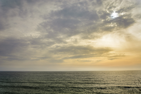 Sea and vibrant sky background as sunsetの写真素材