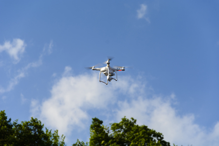 Drone flying against cloudy blue sky. place for textの写真素材