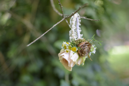 Wedding Floral Bracelet on the grass, with pine cone and rosesの写真素材