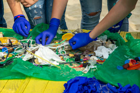 Cigarette butts thrown on a beach, trash and dirty