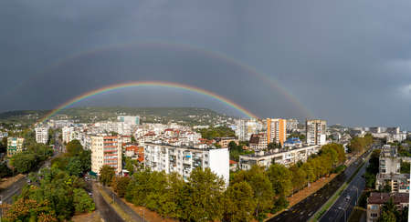 Panoramic shot of a double rainbow with Halo over the city of Varnaのeditorial素材