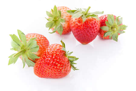 Five red strawberries on white backgroundの写真素材