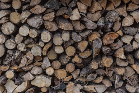 Stacking pile of rough cut firewood, various in sizesの写真素材