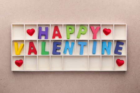 Wooden box of Happy Valentine's wooden alphabets on top of ilight wood backgroundの写真素材