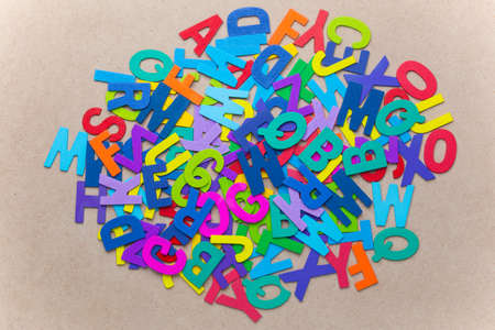 Random color wooden alphabets pile on wood backgroundの写真素材