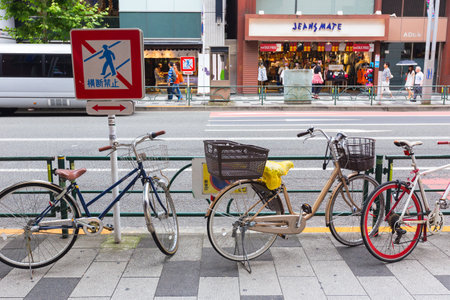 TOKYO, JAPAN - 17 July 2016 - Bicycles parks along street of Tokyo on July 17, 2016.のeditorial素材