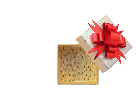 Gold color gift box with red bow on isolated white background, copy space for textの写真素材