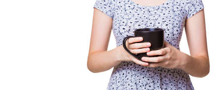 Woman's hands holding black coffee cup, isolated white background with copy spaceの写真素材