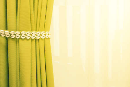 Close up of bedroom curtain with decrorated sea shell strap and vintage lighting effectの写真素材