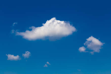 White fluffy clouds against deep blue sky