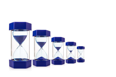 six hourglasses on white background showing blue sand dropping down, mearsure and concept of time, room for copy space, selective focus at the center of hourglassの写真素材