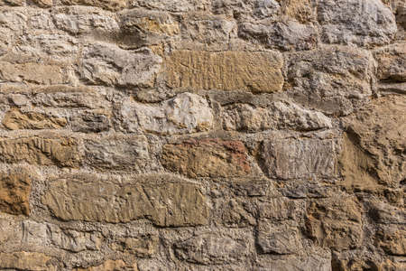 close up of weathered stone wall showing natural stone texture, good for using as backgroundの写真素材