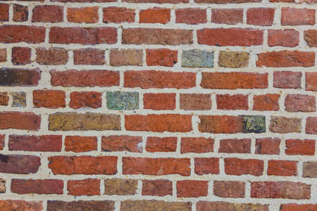 old brick wall with multi-colored bricks, good for backgroundの写真素材