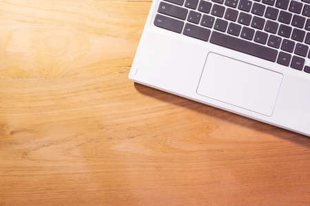 white laptop notebook computer on wooden table background with room for copyspace, good for using as...