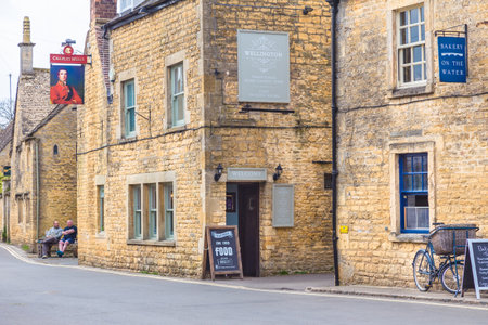 Bourton On The Water, England - 7 April 2017 - Old stone buildings stand along a road in Bourton On The Water, England on April 7, 2017のeditorial素材