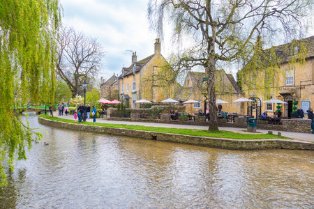 Bourton On The Water, England - 7 April 2017 - People enjoy their day along the water on a fine day at Bourton On The Water, England on April 7th, 2017.のeditorial素材