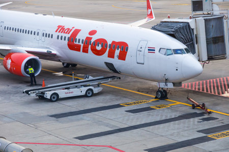 Bangkok, Thailand - 14 September 2017 - Thai Lion Air aircraft waits for passengers while technician...
