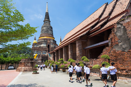 Ayudhaya, Thailand - 14 September 2017 - Local Thai school students visit a famous temple, Wat Yai Chai Mongkol, in Ayudhaya, Thailand on their school field trip on September 14, 2017.のeditorial素材
