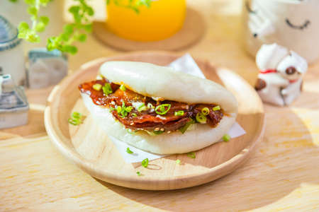 Korean style spicy pork stream bun on wooden trayの写真素材