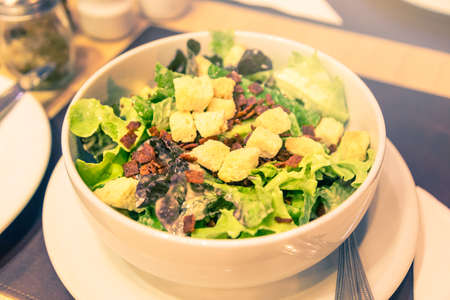 Caesar salad in a bowl, selective focus and vintage color tone, good for heathy lifestyle or diet theme conceptの写真素材