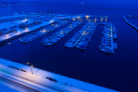 HIdaka, Hokkaido, Japna - 29 December 2017 - The boats dock at night on a cold snowing winter night in the peir of Hidaka, Hokkaido, Japan on December 29, 2017のeditorial素材
