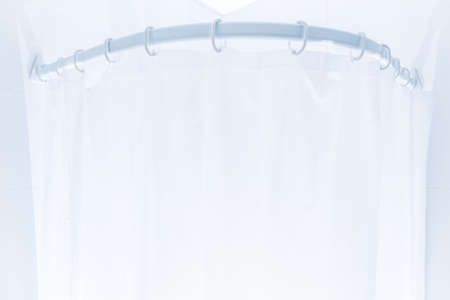 White plastic shower curtain in white bathroomの写真素材