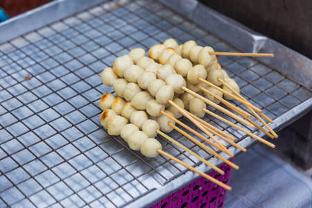 A tray of pork meatballs on skewers selling at a local market in Thailandの写真素材