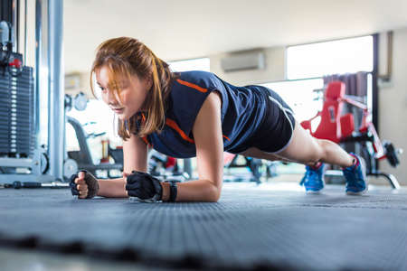 Young Asian woman working out and doing fitness training at a local gym, good for young healthy lifestyle or fitness conceptの写真素材