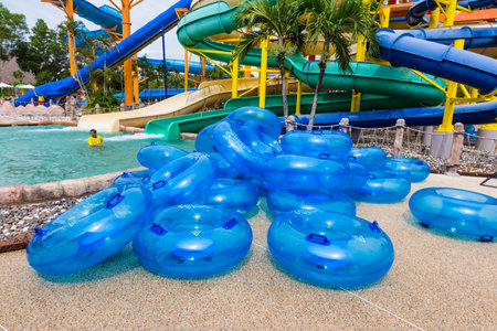 PHUKET, THAILAND - 8 JULY 2017 - Pile of Water floaters waits for people to use on water slide at Splash Jungle Water Park in Phuket, Thailand on July 8, 2017のeditorial素材