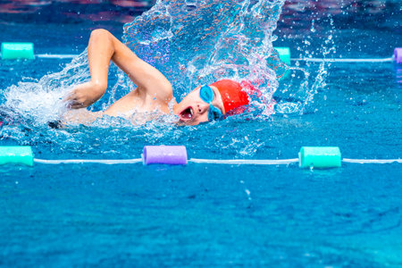 Chiang Mai, Thailand - 4 October 2018 - Young boy swimmer practices his freestyle stroke at a local swimming pool in Chiang Mai, Thailand on October 4, 2018のeditorial素材