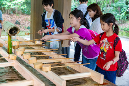 Tokyo, Japan - 14 June 2015 - Tourists and visitors wash their hands and mouths at the water fountain before entering the shrine in Tokyo, Japan on June 14, 2015のeditorial素材