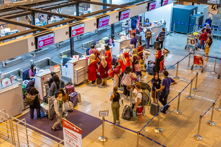 Bangkok, Thailand - 9 July 2019 - Passengers wait in line to check in their flight at Don Mueang...