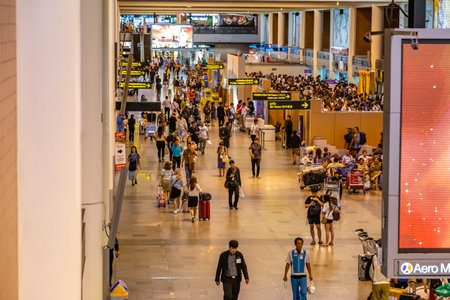 Bangkok, Thailand - 9 July 2019 - Passengers wait in line to check in their flight at Don Mueang International Airport check in counters in Bangkok, Thailand on July 9, 2019のeditorial素材