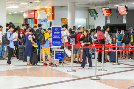 Chiang Mai, Thailand - 14 July 2019 - Lots of air travellers wait in line to check in on their flight at Chiang Mai International airport, Thailand on July 14, 2019のeditorial素材