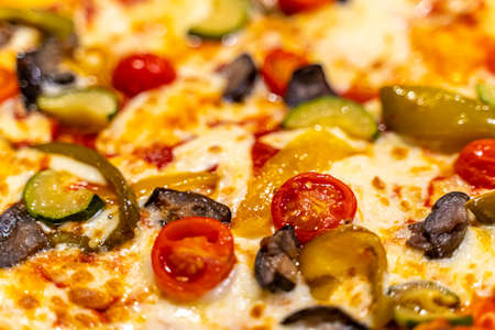 Close up of delicious Italian vegetable cheese pizza showing its vegetable toppings and cheeseの写真素材