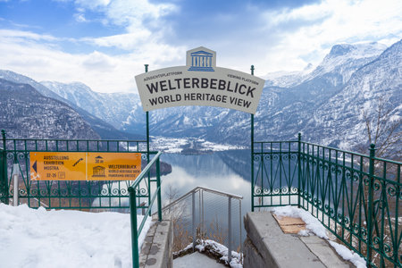 Hallstatt, Austria - 8 April 2015 - Welterbeblick sign over looking Hallstatt lake and snow mountain range on a cold spring day in Hallstatt, Austriaのeditorial素材