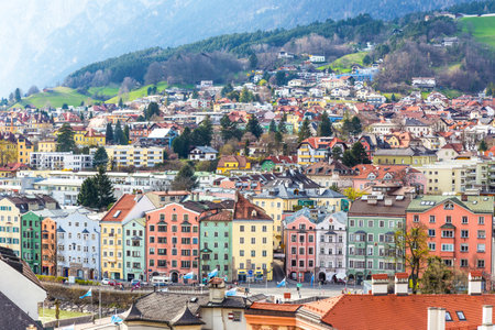 Innsbruck, Austria - 9 April 2015 - Aerial view of colorful buildings and mountains of Innsbruck, Austria on a bright day of April 9, 2015のeditorial素材