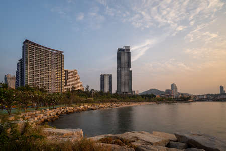 Beautiful view of the Sriracha beach and highrise buildings during one sunset evening showing golden colors on buildings and skyの写真素材
