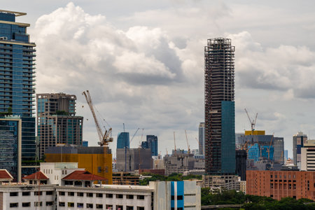 Bangkok, Thailand - 12  August 2022 - Large working construction cranes working on building high-rise buildings in Bangkok, Thailandのeditorial素材