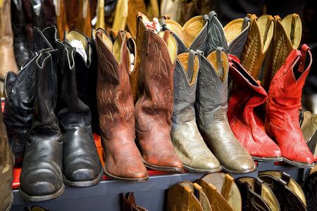 A collection of cowboy boots in rows
